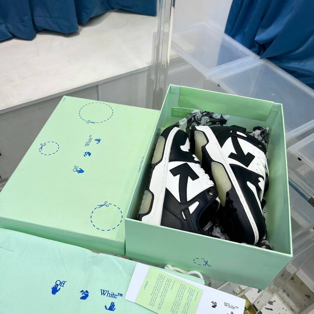 Off White sneakers displayed in their green box, showcasing a stylish black and white design.